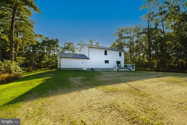 view of side of property featuring a yard and a deck