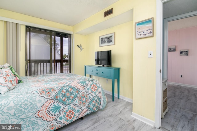 bedroom featuring access to outside and light hardwood / wood-style floors