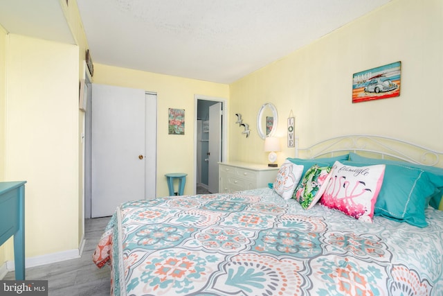 bedroom with a closet and hardwood / wood-style flooring