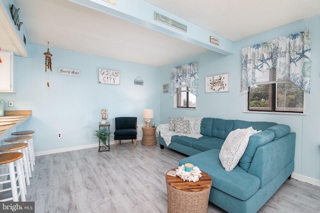 715 142nd St Unit 42304, Ocean City, MD 21842 - living room featuring baseboards, light wood-type flooring, and beam ceiling