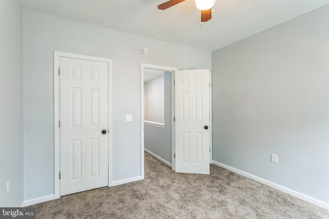 unfurnished bedroom featuring light colored carpet and ceiling fan