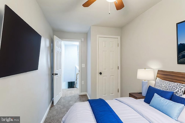 carpeted bedroom with a closet and ceiling fan