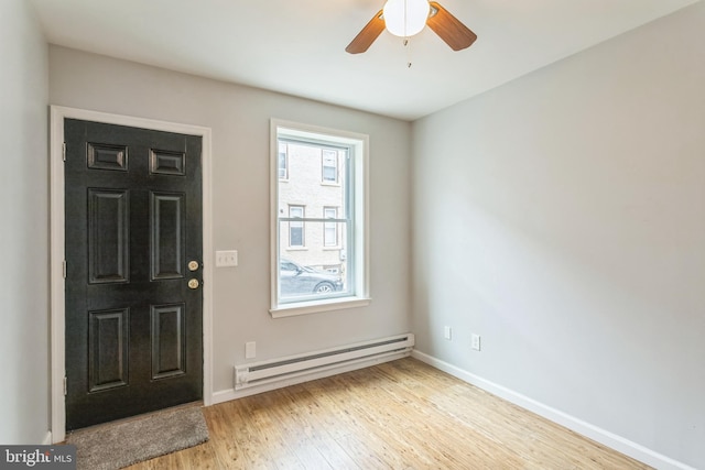 entrance foyer featuring a baseboard radiator, light hardwood / wood-style flooring, and ceiling fan