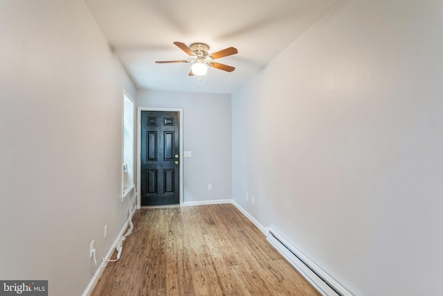 entrance foyer featuring ceiling fan, baseboard heating, and light wood-type flooring