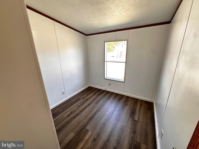 unfurnished room featuring dark hardwood / wood-style floors, crown molding, and a textured ceiling