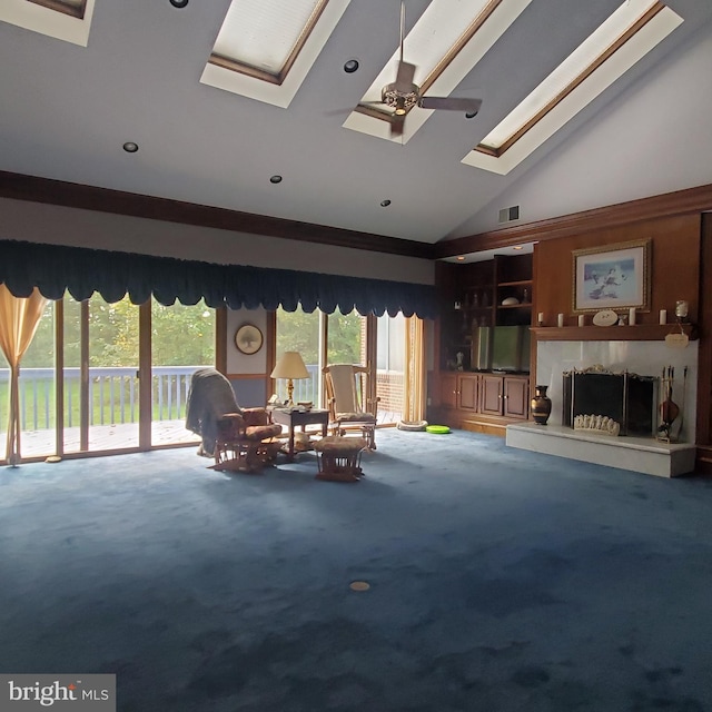 unfurnished living room featuring a skylight, high vaulted ceiling, ceiling fan, and carpet flooring