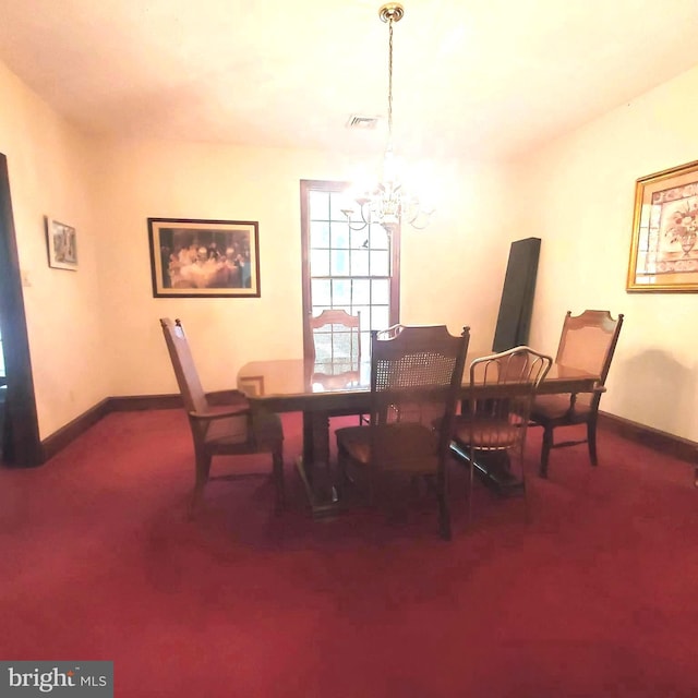 carpeted dining area featuring a chandelier