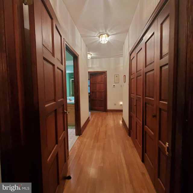 hallway with light hardwood / wood-style flooring