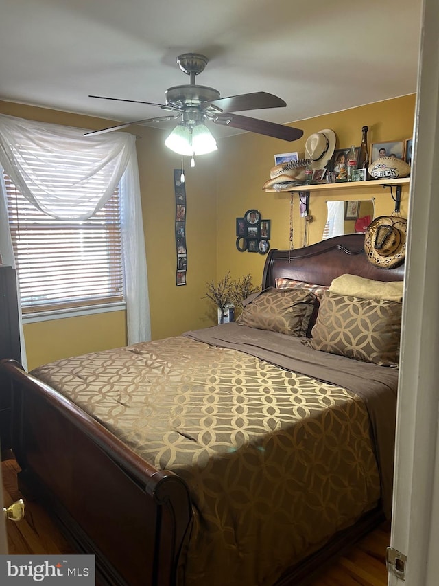 bedroom with ceiling fan and wood-type flooring