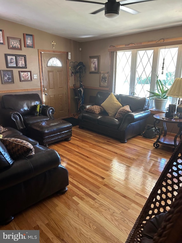 living room featuring light wood-type flooring and ceiling fan