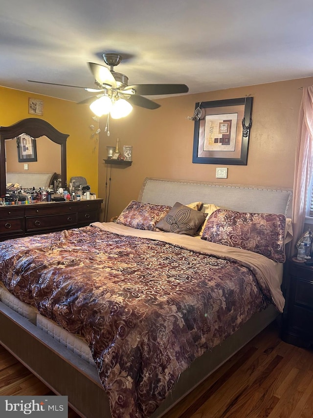 bedroom featuring dark hardwood / wood-style flooring and ceiling fan