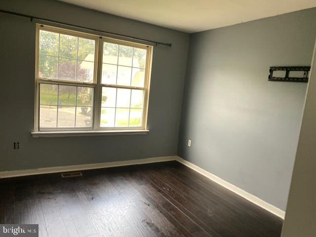 empty room featuring dark hardwood / wood-style floors