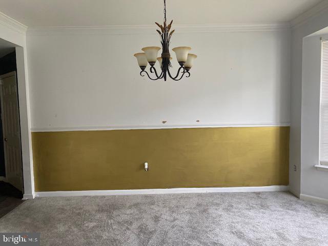 3004 Eider Ct, Waldorf, MD 20601 - unfurnished dining area featuring carpet, crown molding, and a chandelier