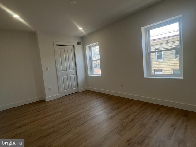 unfurnished room featuring dark wood-type flooring