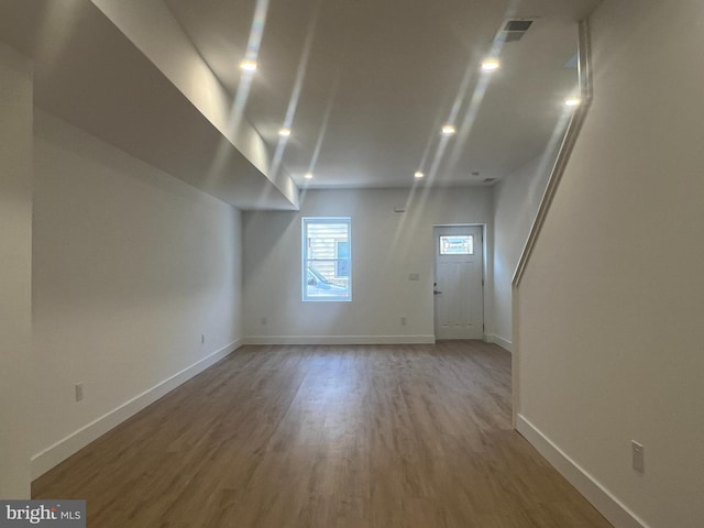 interior space featuring visible vents, recessed lighting, baseboards, and wood finished floors