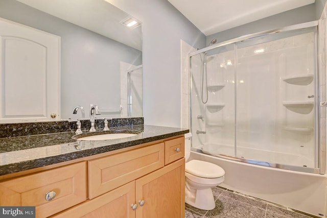 full bathroom with vanity, tile patterned flooring, toilet, and combined bath / shower with glass door