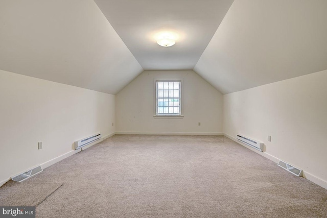 additional living space with a baseboard radiator, vaulted ceiling, and carpet floors