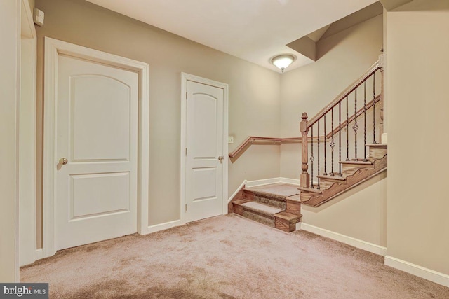 foyer featuring light carpet