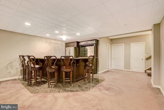 bar featuring white refrigerator and carpet