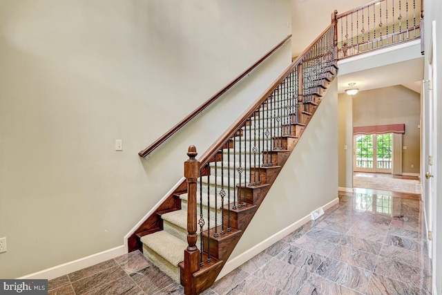 stairs featuring a towering ceiling