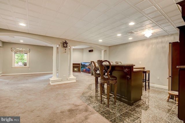 bar with stainless steel fridge and decorative columns