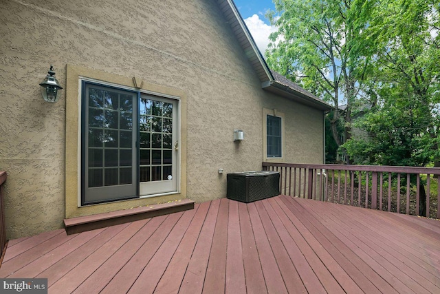 wooden terrace featuring central AC unit