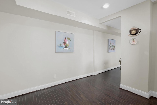 unfurnished room with dark wood-type flooring