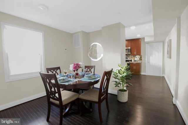 dining space featuring dark wood-type flooring