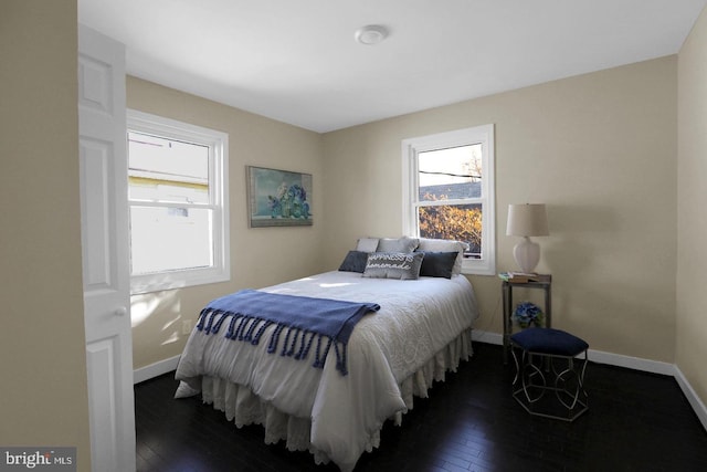 bedroom with dark hardwood / wood-style flooring