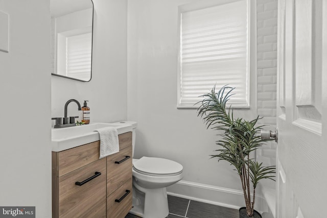 bathroom featuring tile patterned floors, vanity, and toilet