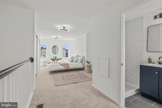 carpeted bedroom with sink