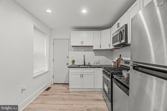 kitchen featuring light hardwood / wood-style flooring, stainless steel appliances, sink, and white cabinetry