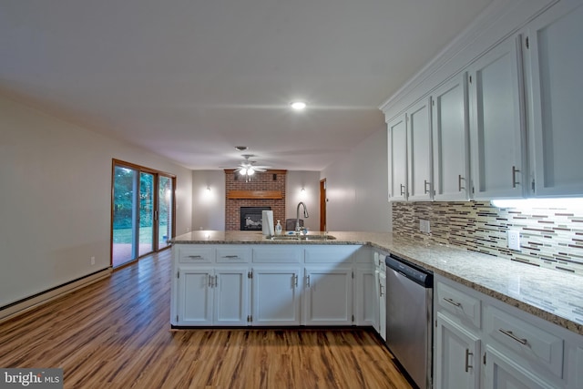 kitchen featuring ceiling fan, sink, kitchen peninsula, white cabinetry, and dishwasher