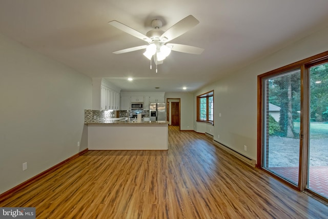 unfurnished living room featuring light hardwood / wood-style floors and ceiling fan