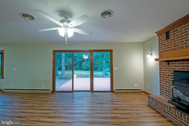 unfurnished living room with a fireplace, hardwood / wood-style floors, ceiling fan, and a baseboard radiator