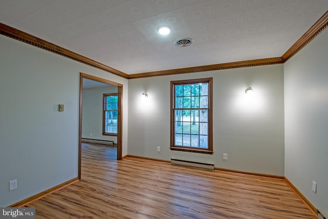 unfurnished room with a baseboard heating unit, light wood-type flooring, and crown molding