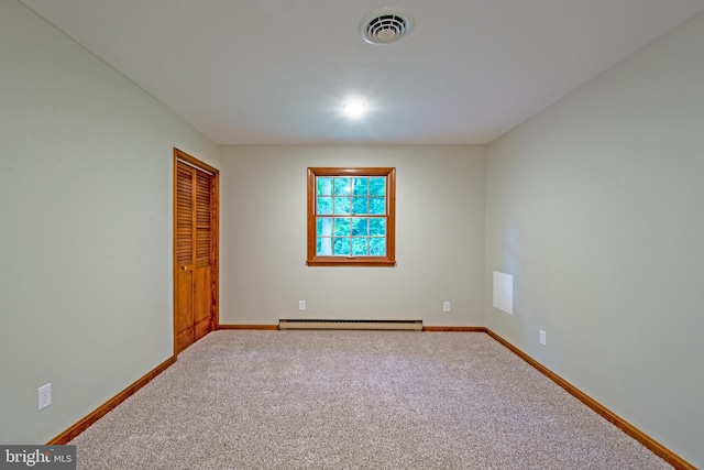 unfurnished room featuring carpet and baseboard heating