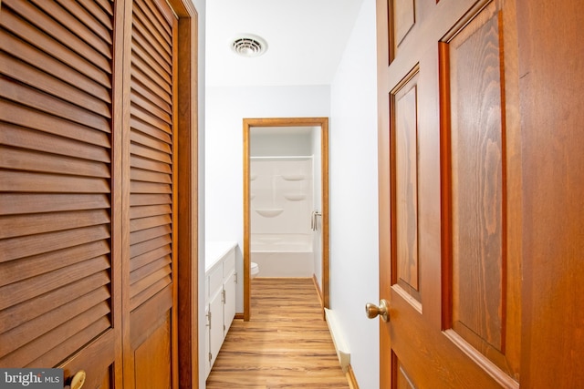 corridor featuring light hardwood / wood-style floors