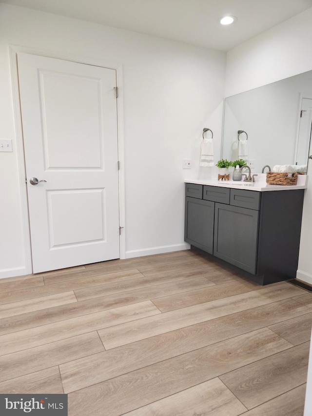 bathroom with wood-type flooring and vanity