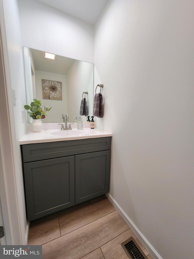 bathroom featuring hardwood / wood-style flooring and vanity