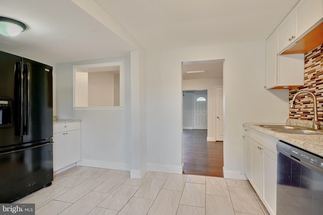 kitchen featuring white cabinetry, black fridge with ice dispenser, dishwasher, light wood-type flooring, and sink