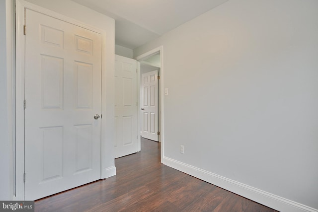 unfurnished bedroom featuring dark hardwood / wood-style flooring