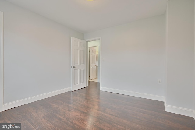 unfurnished room featuring dark hardwood / wood-style floors