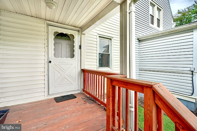 view of exterior entry with a wooden deck