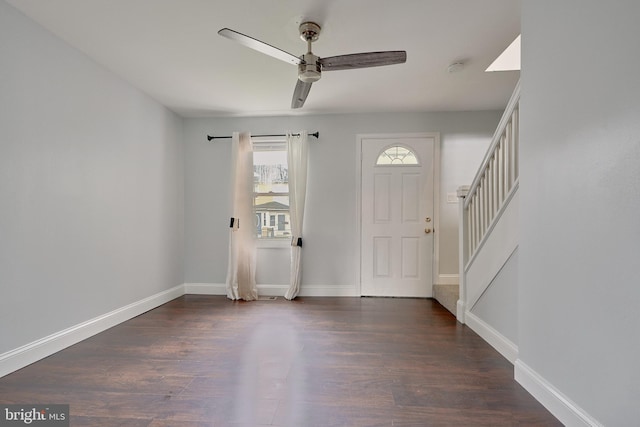 foyer entrance with ceiling fan and dark hardwood / wood-style flooring