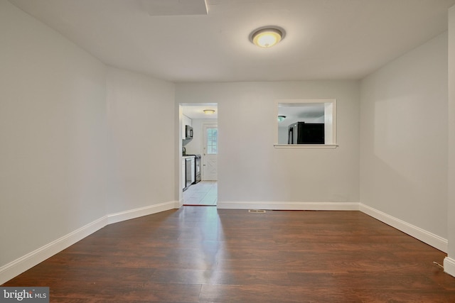 spare room with dark hardwood / wood-style flooring