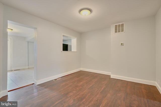 unfurnished room with light wood-type flooring