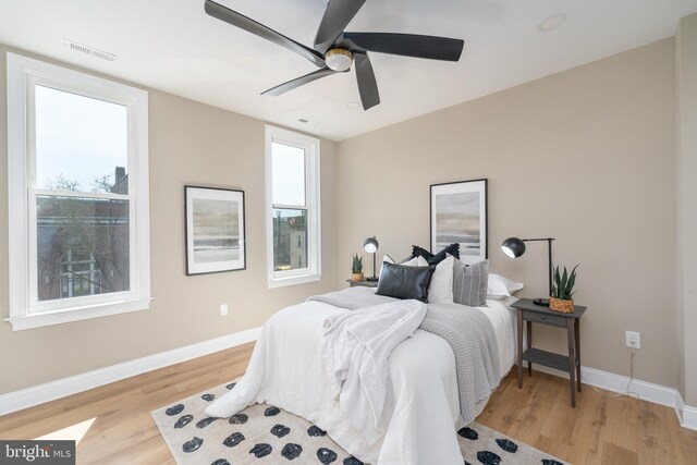 bedroom with light hardwood / wood-style floors and ceiling fan