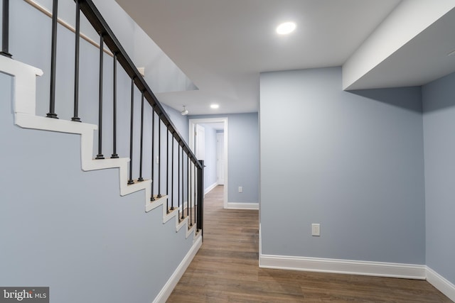 staircase featuring wood-type flooring