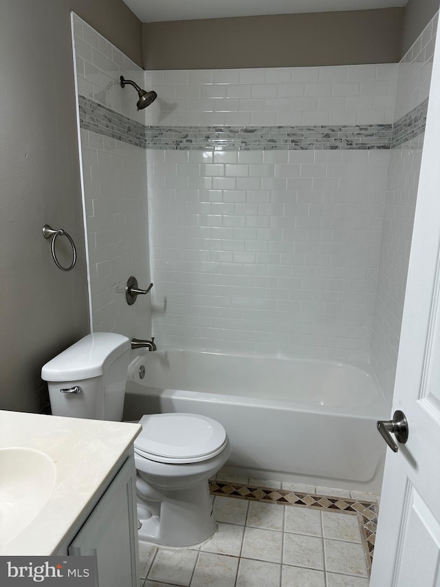 full bathroom with tiled shower / bath, vanity, tile patterned flooring, and toilet